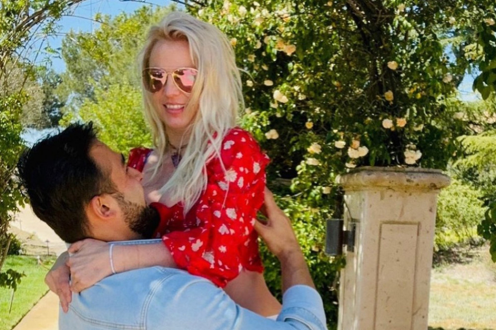 Britney Spears straddled husband Sam Asghari in a series of intimate snaps marking more than a year of their marriage