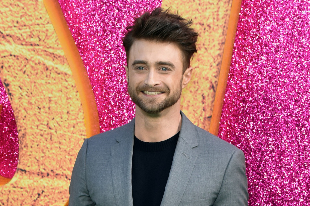 Daniel Radcliffe has admitted he wasn't well behaved when his castmates Emma Watson and Rupert Grint had to film a kissing scene