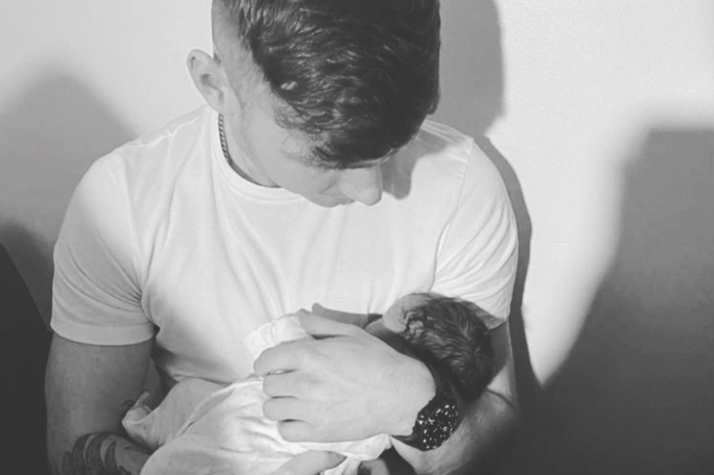 Jack Keating shared a picture of himself holding his new baby daughter