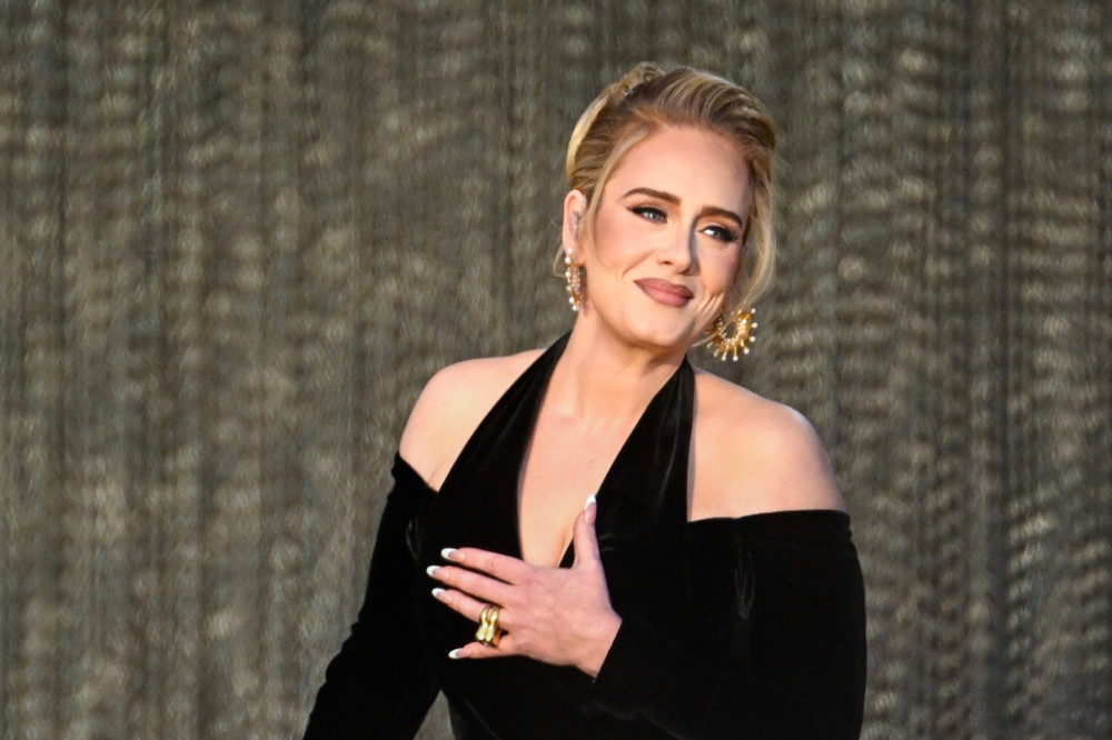 Adele has joked her boyfriend was ‘livid’ after a fan apparently tried to woo her with his phone number