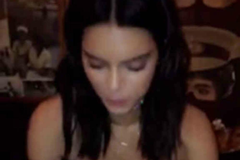 Kendall Jenner eating a burger via Bella Hadid's Snapchat