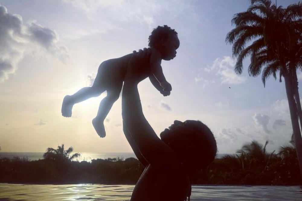 Rihanna has shared a picture of her son RZA as she continues her paradise holiday while waiting on the arrival of her second child