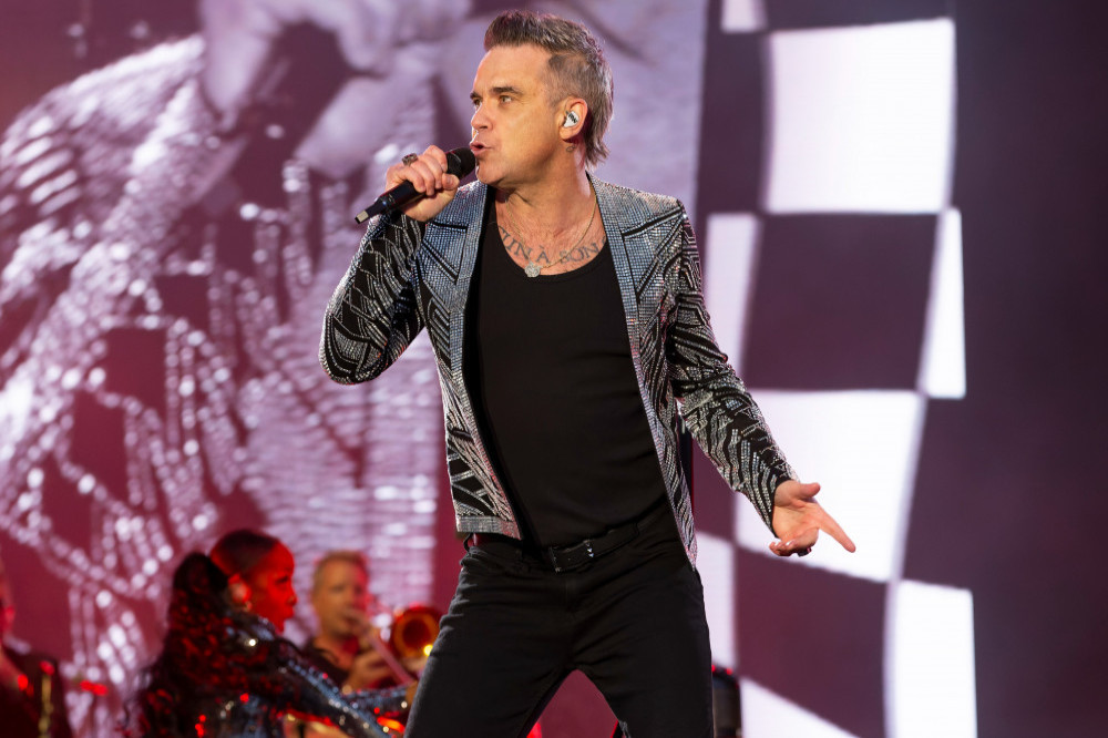 Robbie Williams wants to rock out on a cover of 'It's Raining Men'