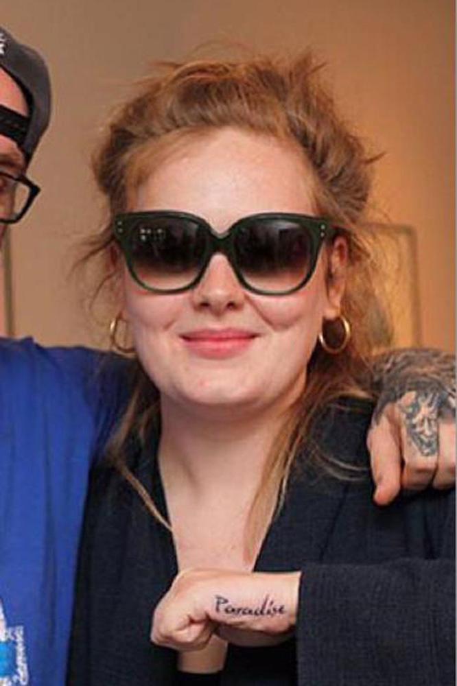 Adele showing off tattoo with Bang Bang 