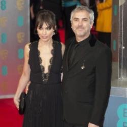 Alfonso Cuarón and his partner Sheherazade Goldsmith arriving at the BAFTAs