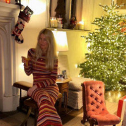 Claudia Schiffer showed fans she celebrated Christmas by hanging out a customised Versace stocking and filling her mansion with ornaments and vintage wines