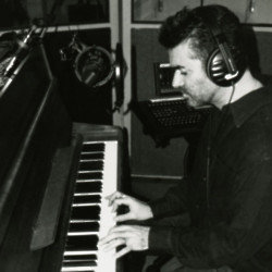 George Michael playing John Lennon's piano