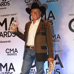 George Strait with his award at the CMAs