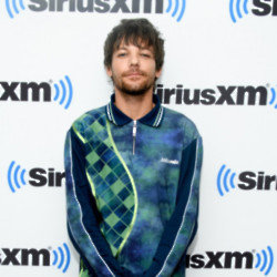Louis Tomlinson is 'irritatd' by the conspiracy theory he is in a relationship with Harry Styles