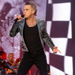 Robbie Williams wants to rock out on a cover of 'It's Raining Men'