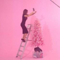 Victoria Beckham wearing heels to decorate her Christmas tree