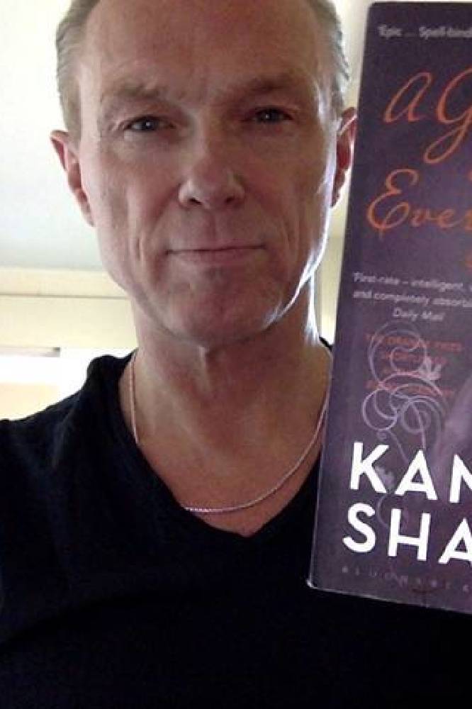 Gary Kemp holding a copy of A God in Every Stone