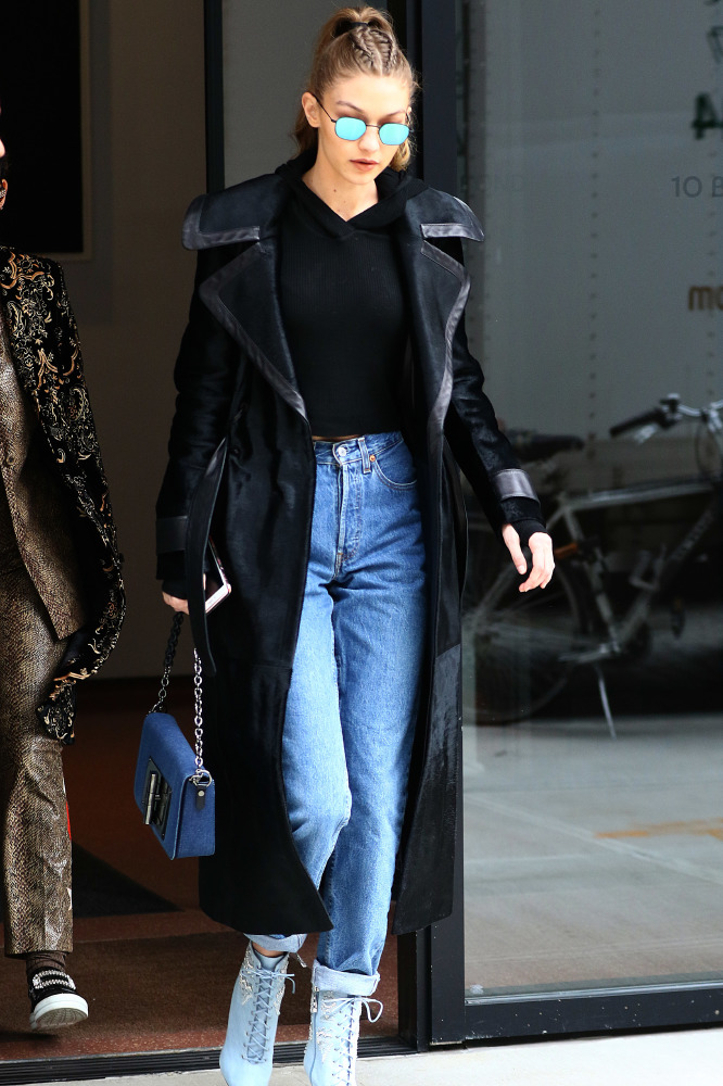 Gigi Hadid in a modern, leather lined, black trench coat