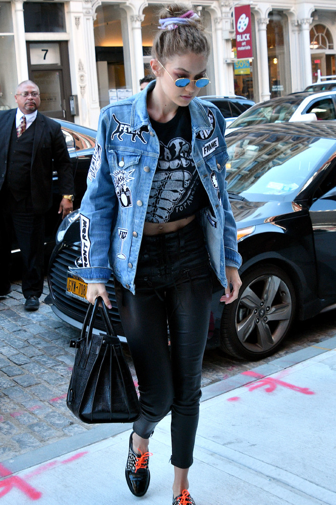 Gigi Hadid rocks a denim jacket and leather look leggings in New York