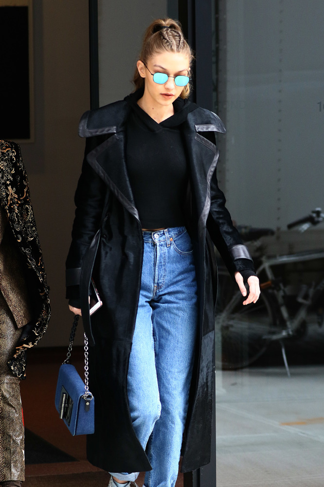 Gigi teams a pair of high heeled blue boots with turned-up jeans