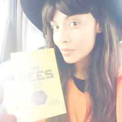 Jameela Jamil holding a copy of The Bees