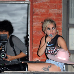 Lady Gaga pictured on a NYC apartment fire escape during filming for 'Joanne' promo