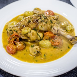 Vinegar and tarragon chicken fricassée with grapes, cherry tomatoes and button mushrooms