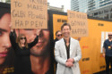 Glen Powell did not seem to mind when his parents held up signs at the red carpet premiere of his movie Hit Man