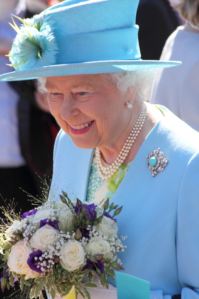 Queen Elizabeth II visiting Matlock Station, July 2014. Perhaps her biggest smile in this collection is complimented perfectly by the stunning sky blue outfit she wears. / Picture Credit: Matthew Taylor/Alamy Stock Photo