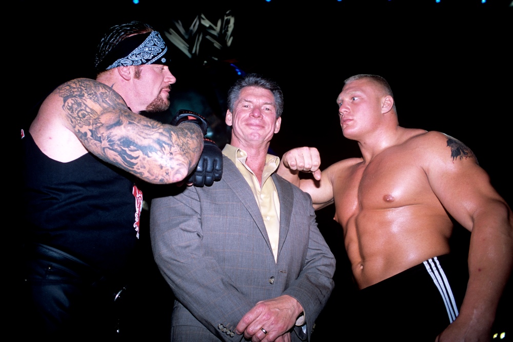 Vince McMahon flanked by The Undertaker and Brock Lesnar, September 2002 / Picture Credit: Simon Galloway/EMPICS Sport