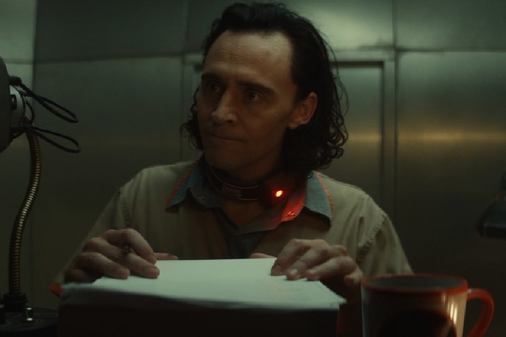 Loki angrily signing papers at the TVA / Picture Credit: Marvel Studios and Disney+