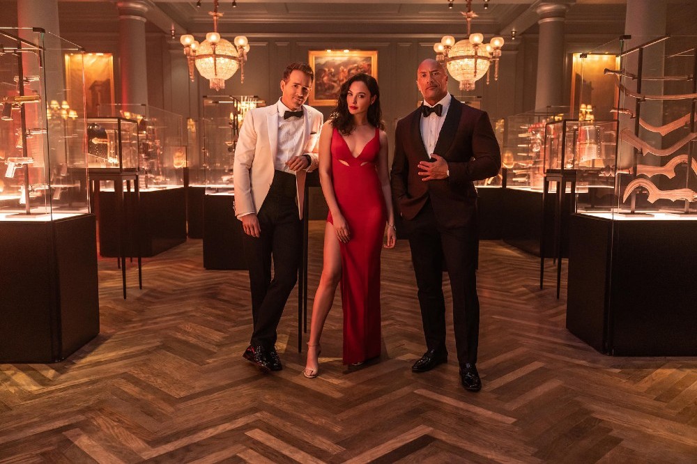 Ryan Reynolds, Gal Gadot, and Dwayne Johnson in first look photo for Red Notice / Picture Credit: Netflix