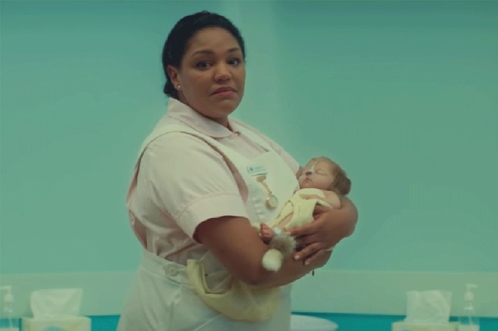 A nurse holding an odd yet adorable hybrid baby / Picture Credit: Netflix