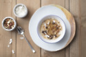 Caramelised pear porridge with cashew nuts and coconut flakes