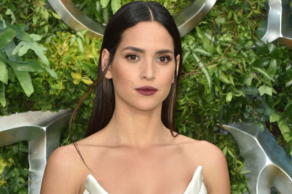 Adria Arjona says her curly hair is her secret weapon