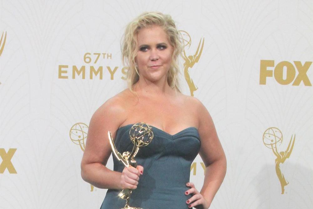 Amy Schumer showing off her Emmy award