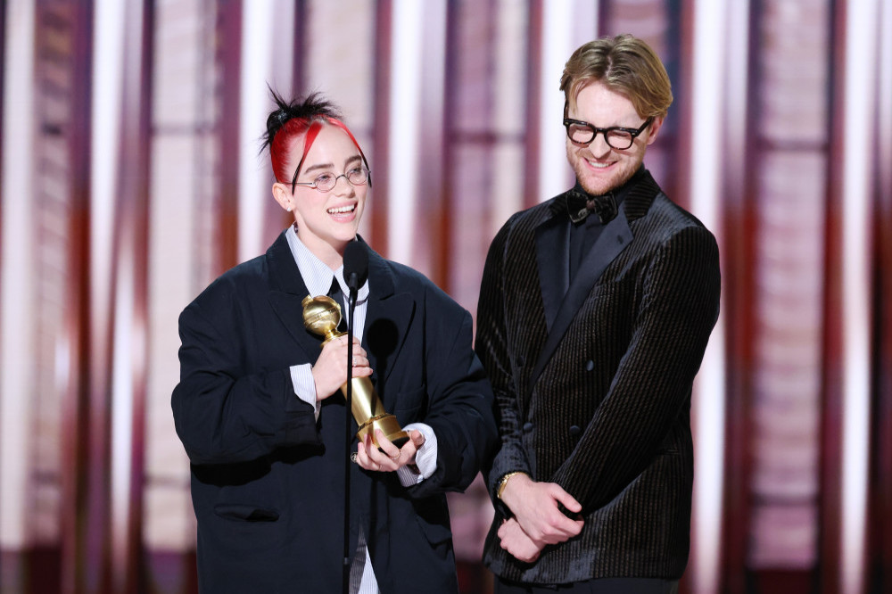 Billie Eilish and Finneas O'Connell accept their Golden Globe Award