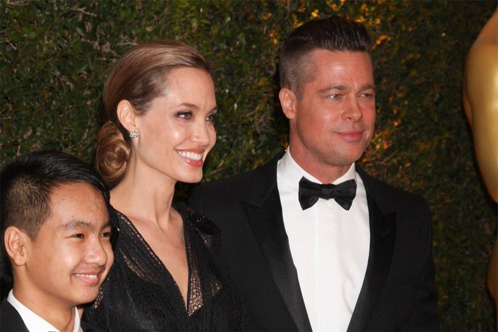 Maddox Jolie-Pitt with Angelina Jolie and Brad Pitt