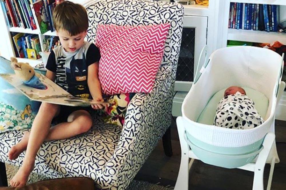 Buzz Fletcher reads to baby brother (c) Instagram 