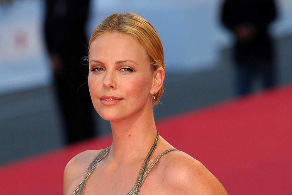 Charlize Theron has complained about how she was dressed by directors in her early film roles
