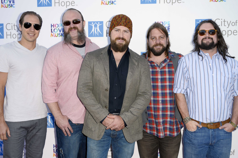 John Driskell Hopkins (centre) has been diagnosed with ALS