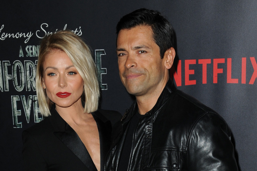 Kelly Ripa says Mark Consuelos is too buff for his clothes
