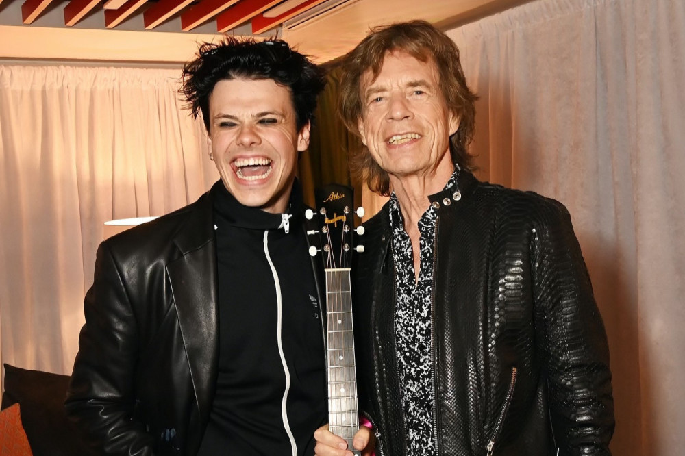 Mick Jagger presenting Yungblud with the guitar