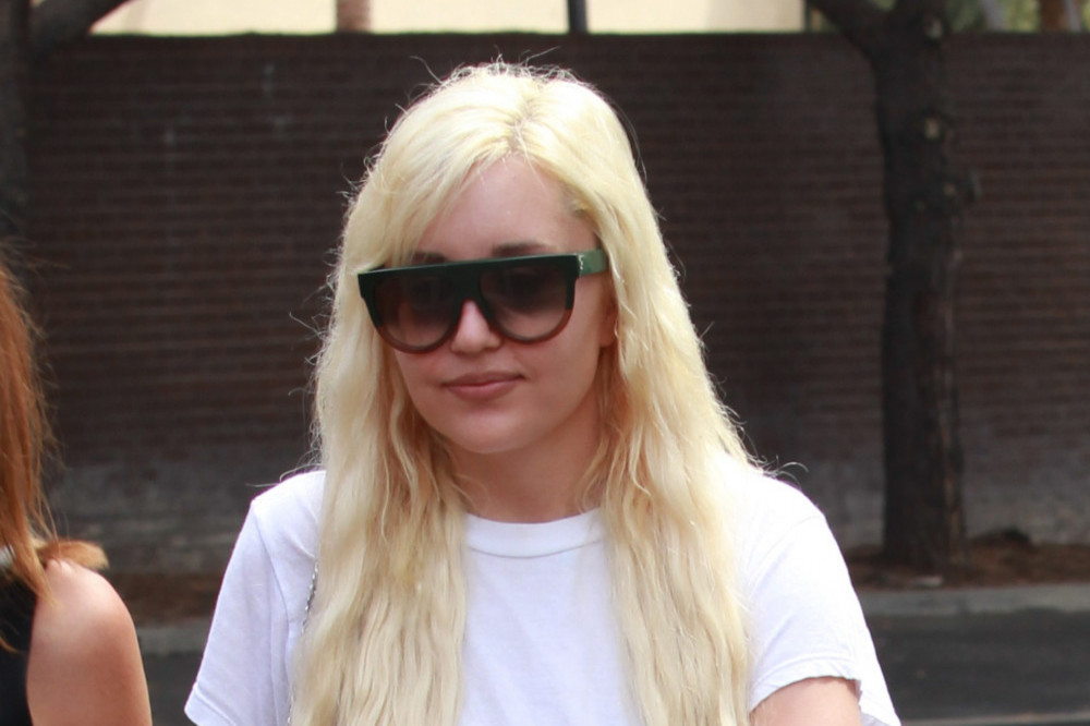Amanda Bynes is a quarter of the way through her cosmetology course
