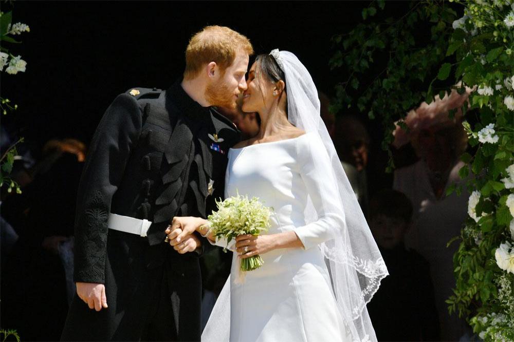 Prince Harry and Duchess Meghan share a kiss