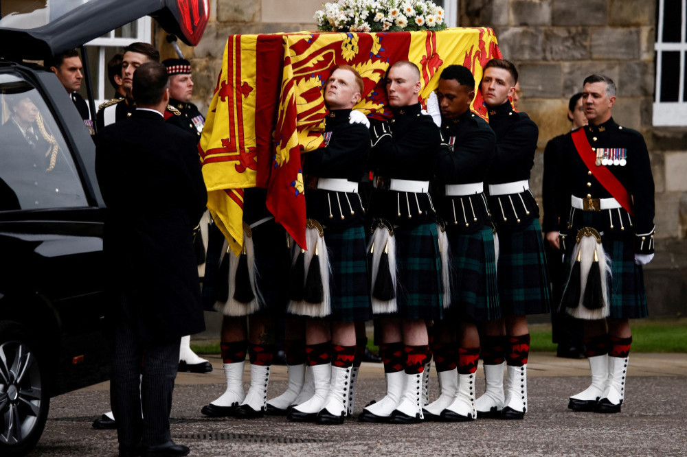 Queen Elizabeth’s grieving children watched as her coffin arrived in Edinburgh to lie in rest at the Palace of Holyroodhouse overnight