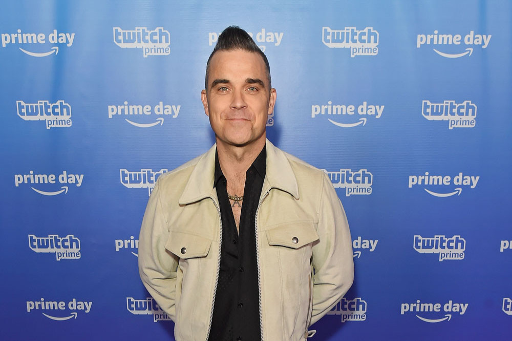 Robbie Williams considers wearing a bra to hold in his man boobs