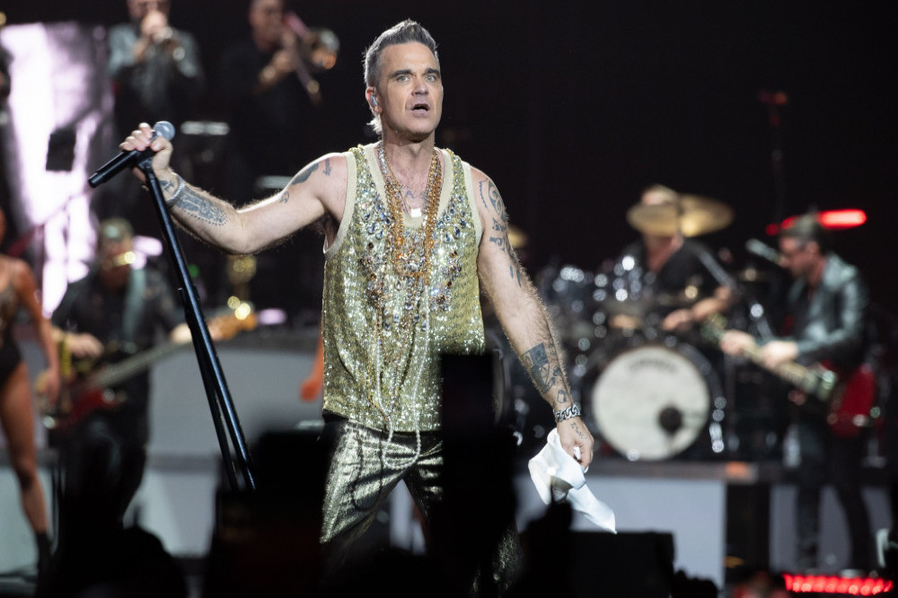 Robbie Williams is helping to boost his pal's music career