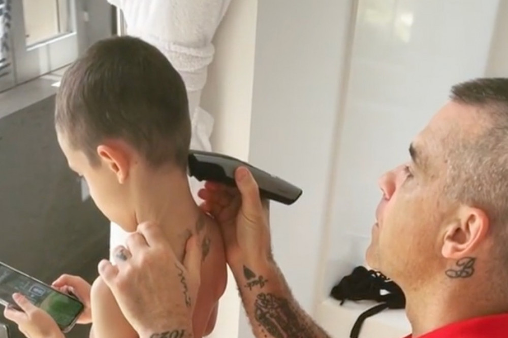 Robbie Williams shaves son Charlie's hair