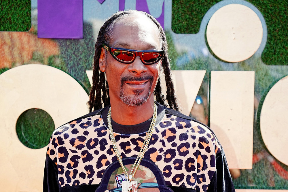 Snoop Dogg smokes up to 150 marijuana joints a day, according to his professional 'blunt roller'