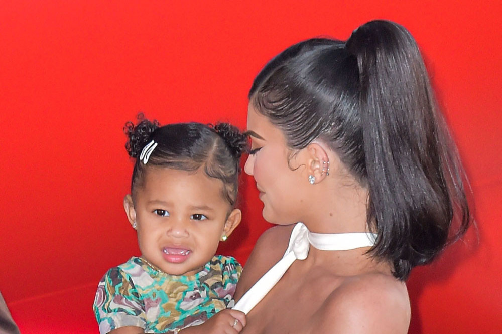 Kylie Jenner shared a previously unseen snap of her daughter kissing her pregnant belly