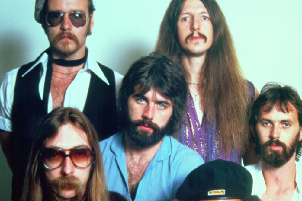 The Doobie Brothers’ original drummer John Hartman – second from bottom left – has died aged 72