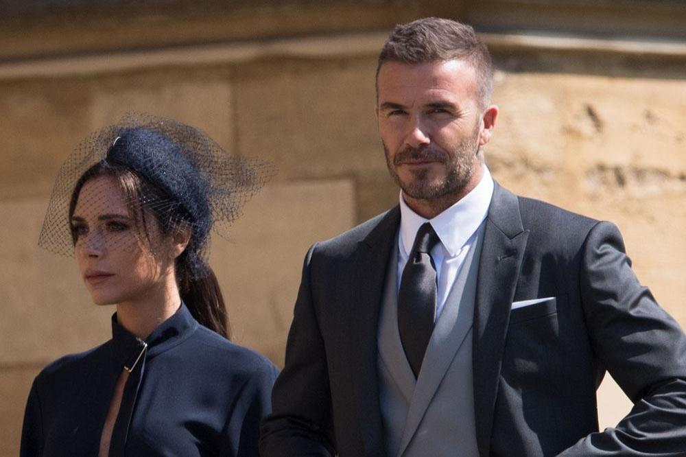 Victoria and David Beckham at the royal wedding/ Photo by Zak Hussein