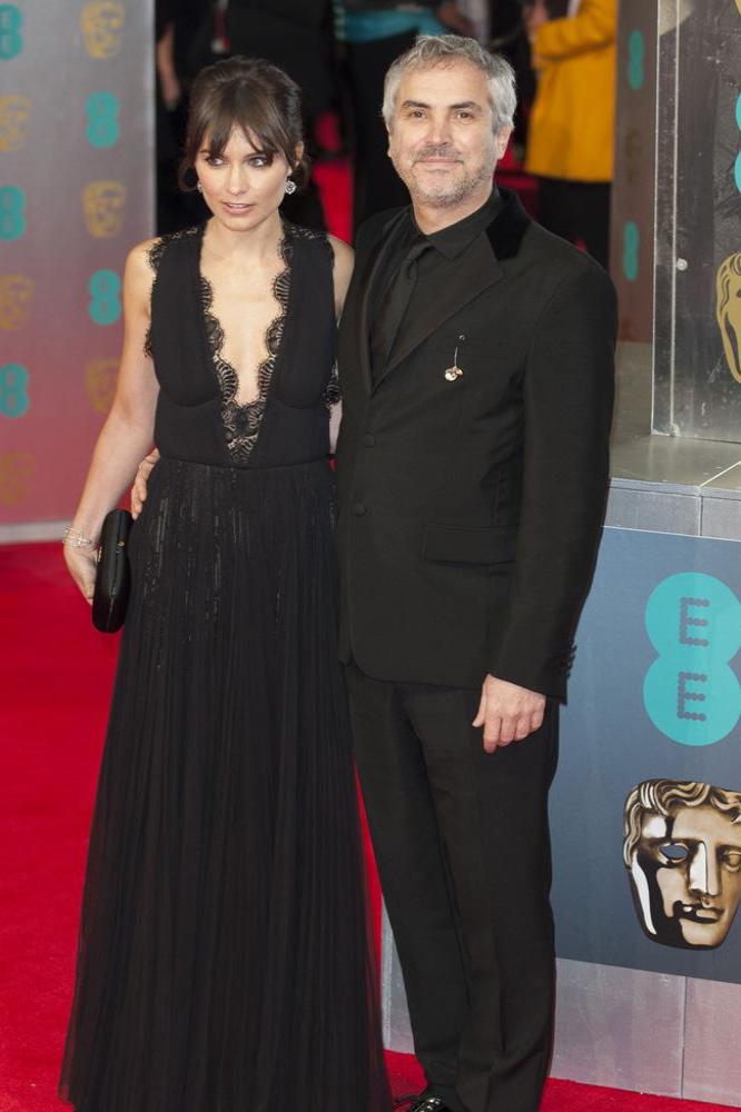 Alfonso Cuarón and his partner Sheherazade Goldsmith arriving at the BAFTAs