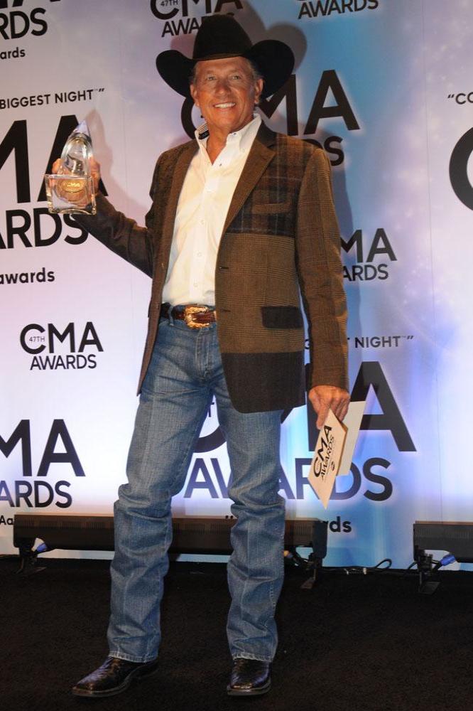 George Strait with his award at the CMAs